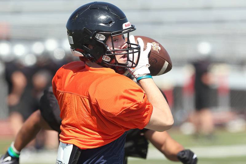 DeKalb's Cooper Phelps hauls in a pass during a joint football practice with Kaneland Thursday, July 14, 2022, at DeKalb High School.