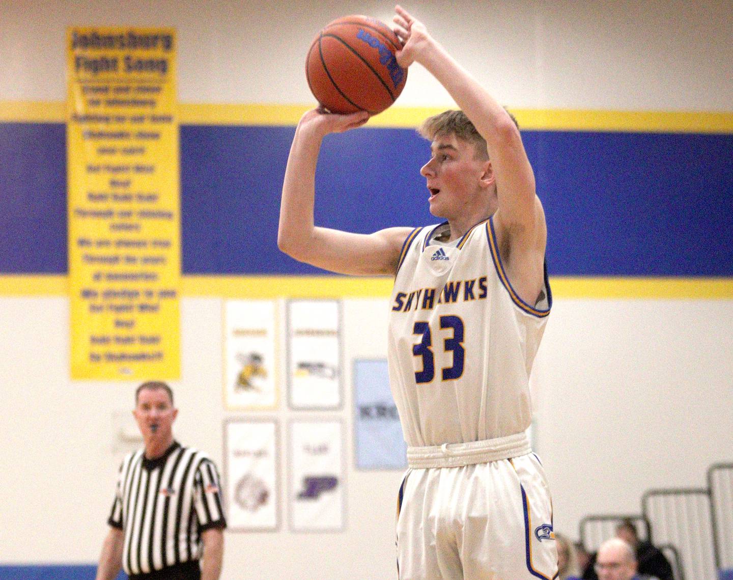 Johnsburg’s JT Schmitt takes an outside shot against Harvard in varsity boys basketball at Johnsburg Saturday.