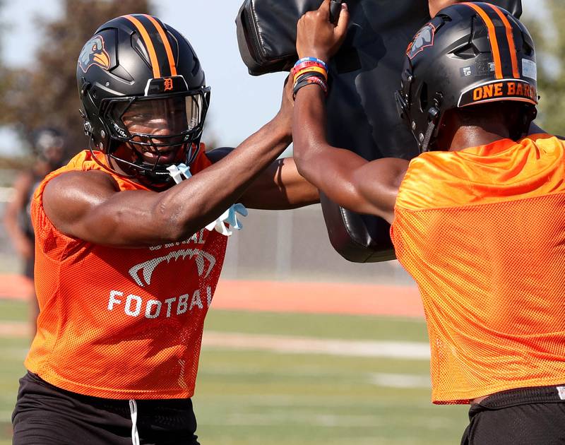DeKalb’s Davon Grant works on shaking off a blocker Monday, Aug. 11, 2025, during their first fall practice at the school.