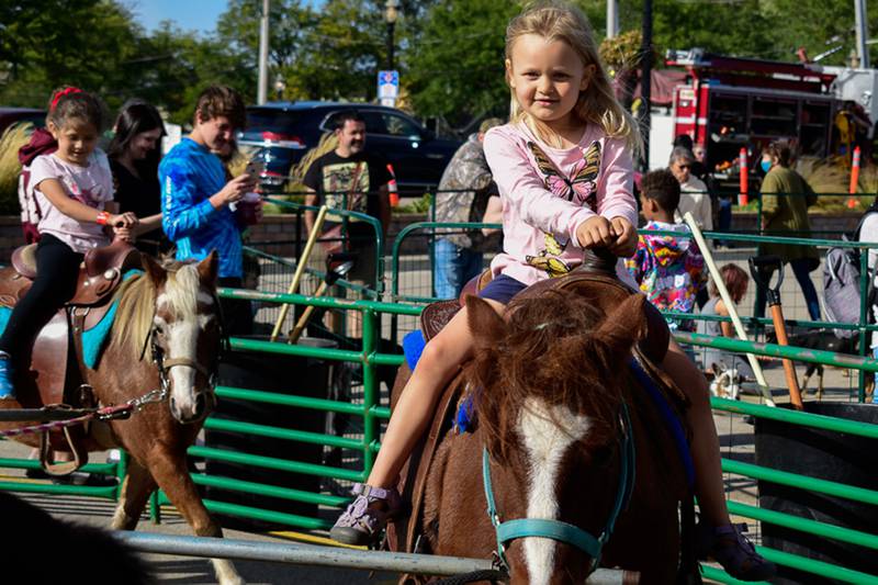 Penelope Currie, 5, rides a horse during the annual Johnny Appleseed festival on Saturday, Sept. 25, 2021, in downtown Crystal Lake.