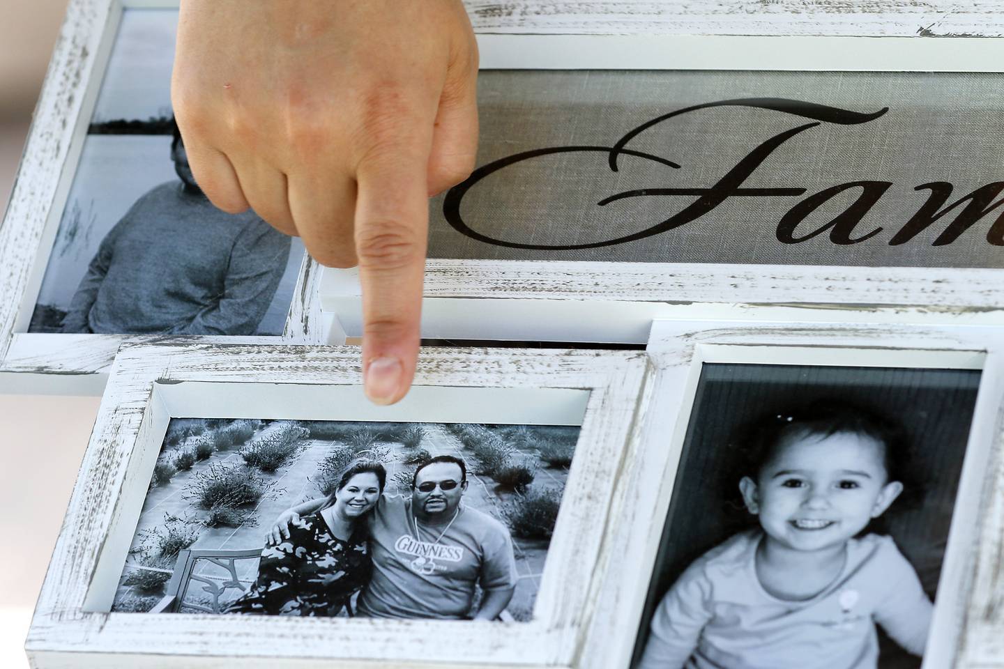 Kristin Glauner points out a family photo of herself and fiance Cesar Elizarraraz at home on Thursday, June 3, 2021 in Crystal Lake. Cesar Mauricio Elizarraraz, father of the five children and fiancee to Kristin Glauner, could potentially be deported back to Mexico on Friday.