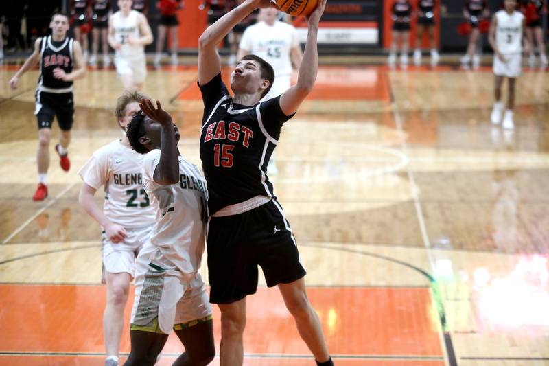 Glenbard East's Jacob Marynowski gets a shot up during a Class 4A St. Charles East Sectional semifinal against Glenbard West on Tuesday, March 4, 2025 in St. Charles.