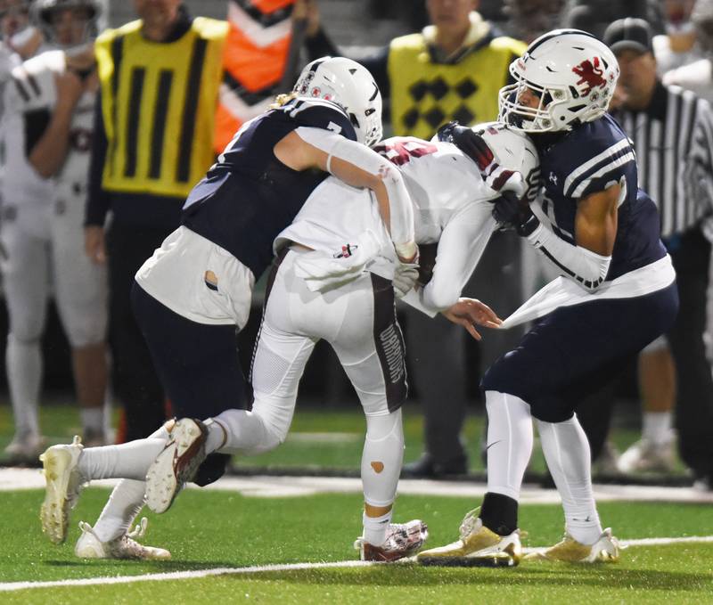 Joe Lewnard/jlewnard@dailyherald.com
Wheaton Academy quarterback Brett Kasper gets sacked by St. Viator 's Michael Tauscher, left, and Jaylan Szlachetka during Friday’s Class 4A football playoff game in Arlington Heights Friday.