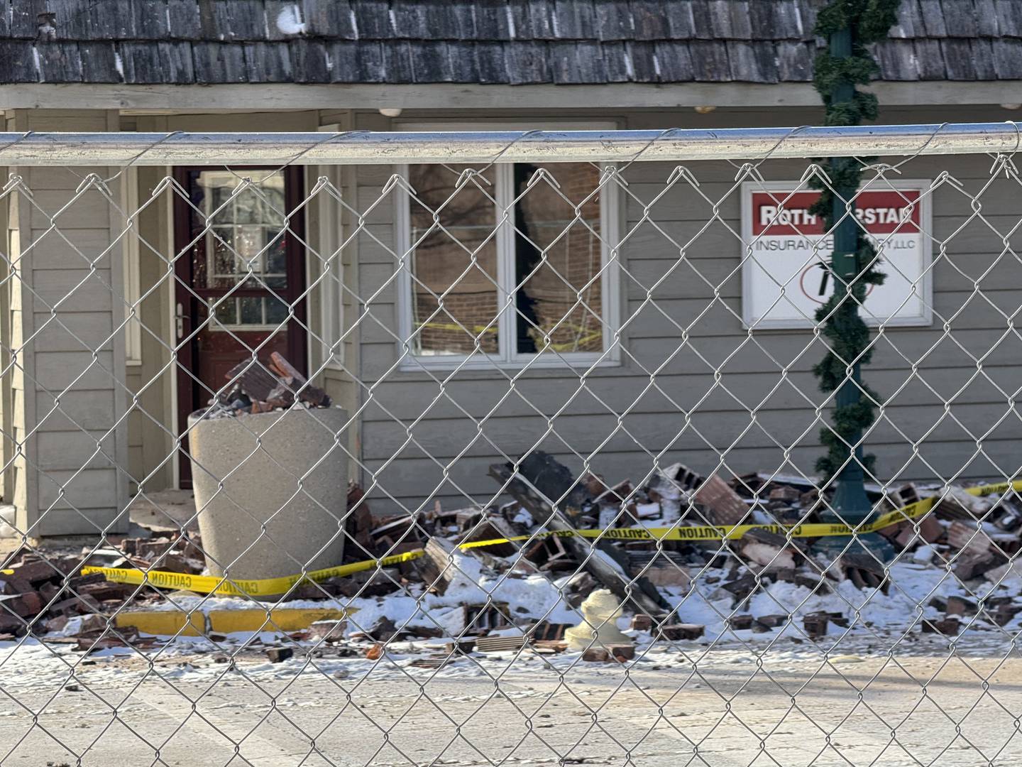 Bricks and remains of the collapsed roof at 322 Liberty St. in Morris.