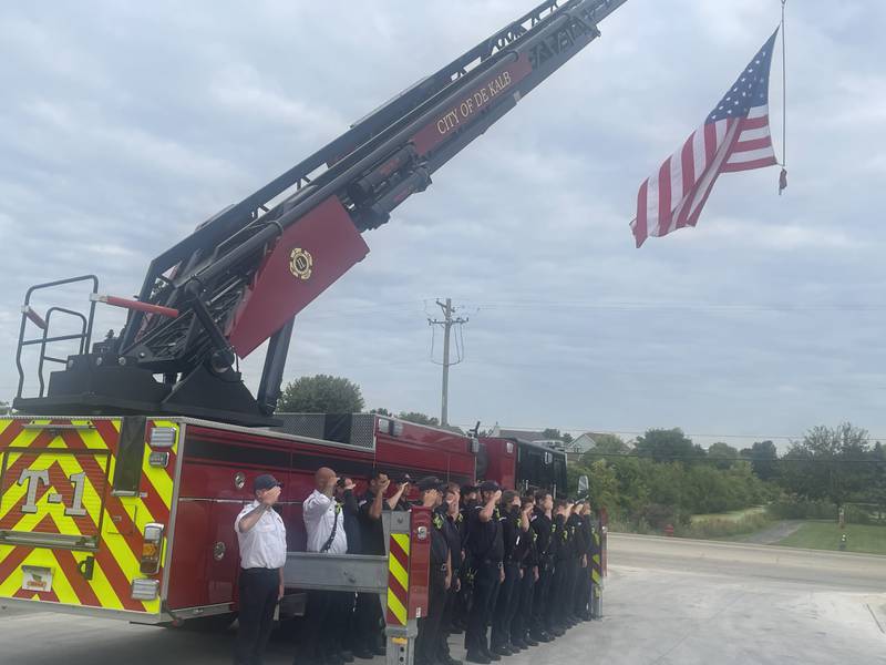 Members of the DeKalb Fire Department give a salute to the American flag Thursday, Sept. 11, 2025, during the fire department's annual Patriot Day Ceremony.