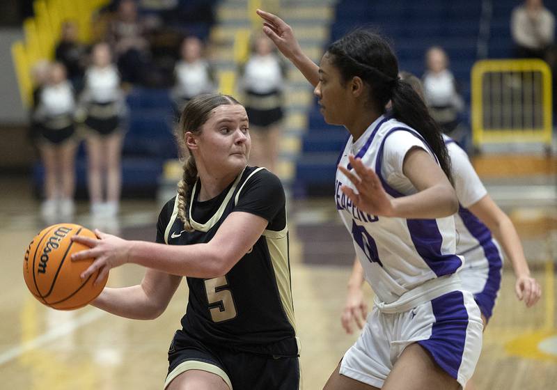 Sycamore’s Grace Amptmann looks to pass against Plano’s Jailyn Brown Monday, Feb. 17, 2025, during a 3A semifinal in Sterling.