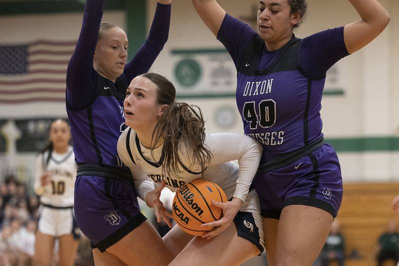Dixon's Makenzie Toms (left) and Hallie Williamson guard Sterling’s Madison Austin Thursday, Feb. 27, 2025, during the Class 3A girls Sectional title at Rockford Boylan High School.