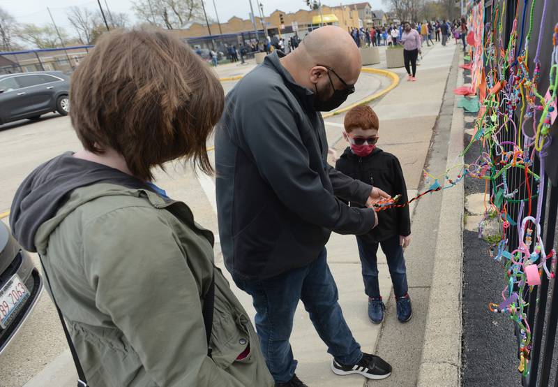 Jefferson Elementary School 1st grader Lucas Sanchez shows his parents Ben and Laura Sanchez his class art during District 98's Dia de los Niños celebration Friday April 29, 2022.