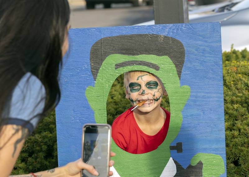 Julyen Canas, 7, of Sterling has his picture taken in one of several Monster Mugshots Tuesday, Oct. 29, 2024, at Sterling PD’s trunk or treat.