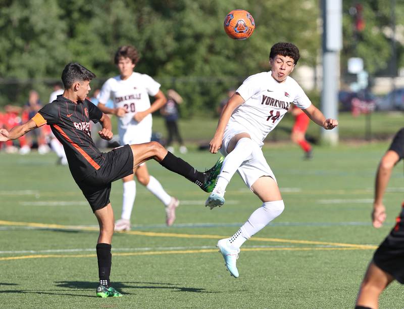 DeKalb's Kendall Gilkey kicks the ball as Yorkville's Ismae González tries to block it during their game Thursday, Aug. 25, 2022, in the Barb Cup at the Northern Illinois University Outdoor Recreation Sports Complex.