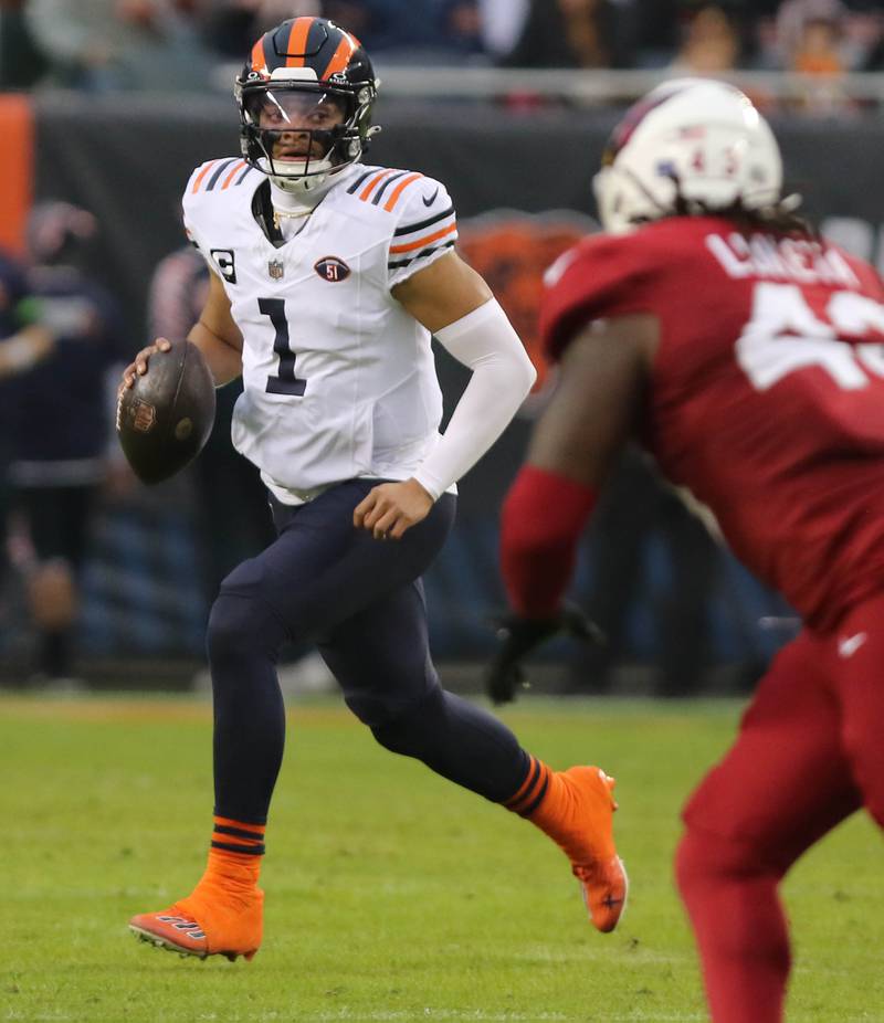 Chicago Bears quarterback Justin Fields scrambles away from the Arizona Cardinals pass rush during their game Sunday, Dec. 24, 2023, at Soldier Field in Chicago.