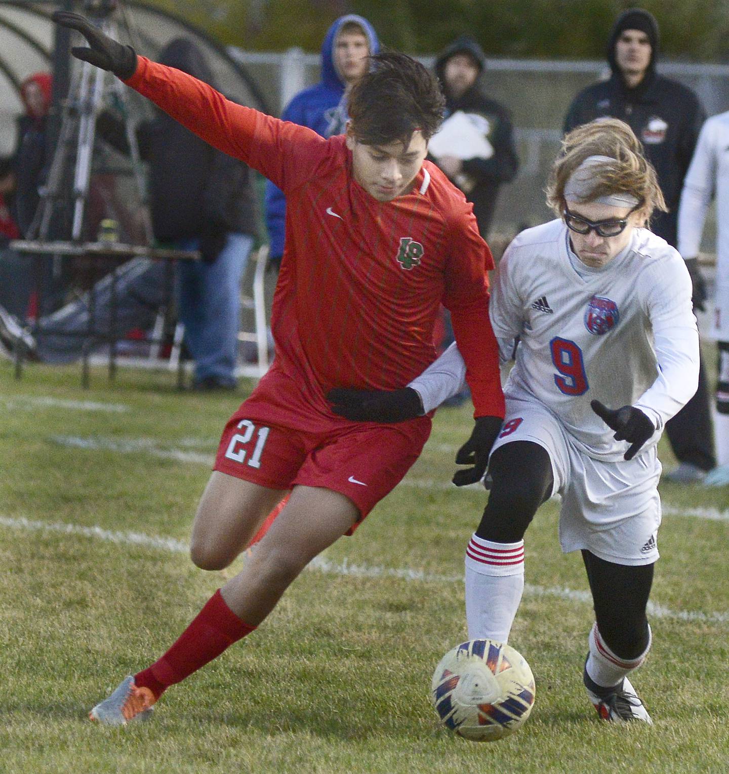 La Salle-Peru's Gianmarco Luna Tejada (21) and Streator’s Connor Akin (9) race to the ball in the first half of the old rivals'Class 2A boys soccer regional semifinal Tuesday, Oct. 18, 2022, in La Salle.
