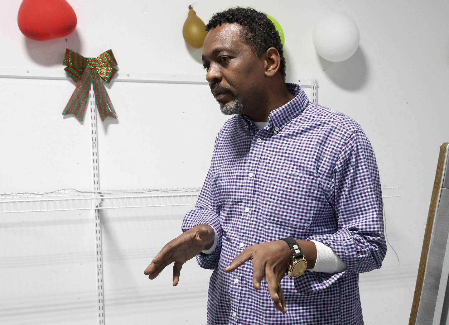 Quick Stop Convenience Store manager Kamal Abdelfadil talks Thursday, Jan. 12, 2026, at the  store in DeKalb, about emloyee Demetrius Page who set up programs to benefit local residents.