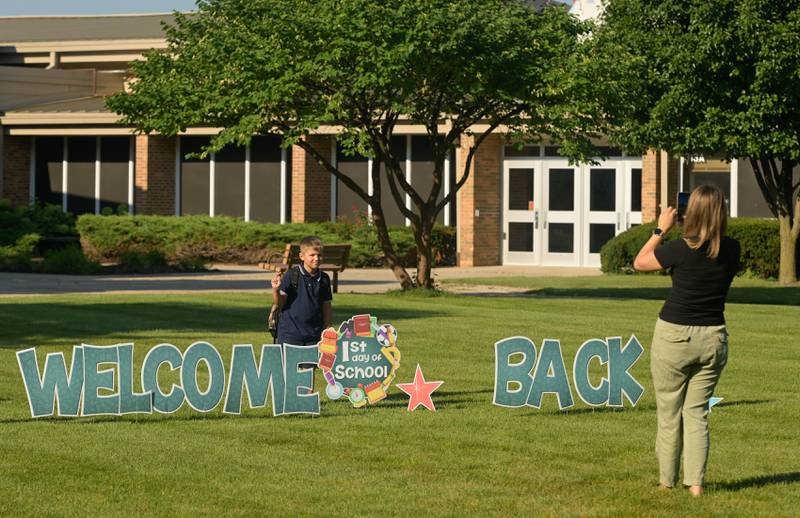 Parents photograph their children in front of the “Welcome Back” sign at Davis Elementary in St. Charles on Wednesday, Aug 13, 2025.