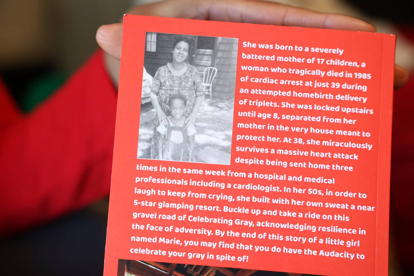 Carla Wills shows one of the few photos of her and her mother on the back of the book she wrote and self-published, titled “Celebrating Gray: Having the Audacity to in spite of."