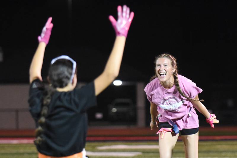 Bradley-Bourbonnais' Shannon Lee, right, and Amber Melchor celebrate after winning a flag-pulling competition at the first day of girls flag football practice Monday, Aug. 11, 2025.