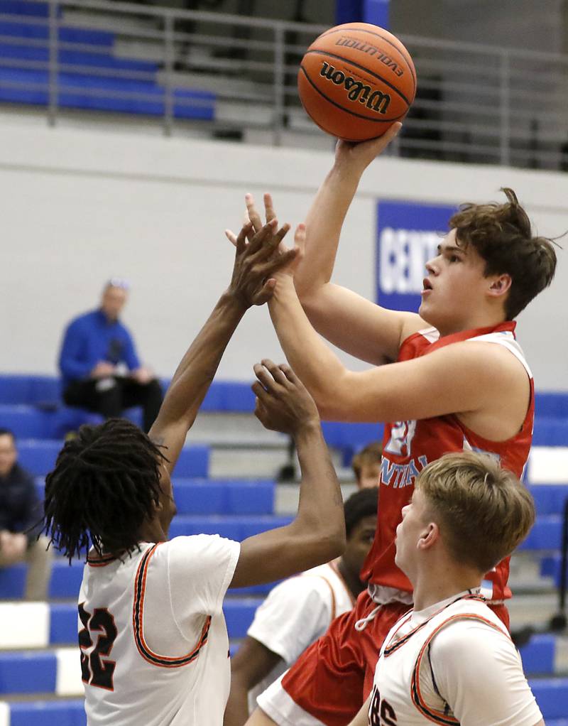 Marian Central's Cale McThenia shoots the ball over DeKalb's Darell Island during a Central High School’s Dr. Martin Luther King, Jr., Boys Basketball Tournament game Friday, Jan. 13, 2023, at Central High School in Burlington.