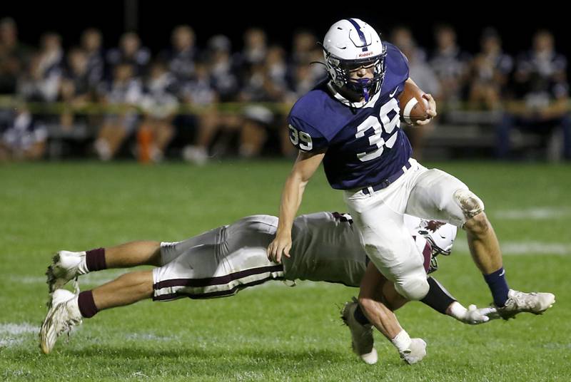 Cary-Grove's Holden Boone is tackled by Prairie Ridge's Dominic Creatore during a Fox Valley Conference football game on Friday, Sept. 22, 2023, at Cary-Grove High School in Cary.
