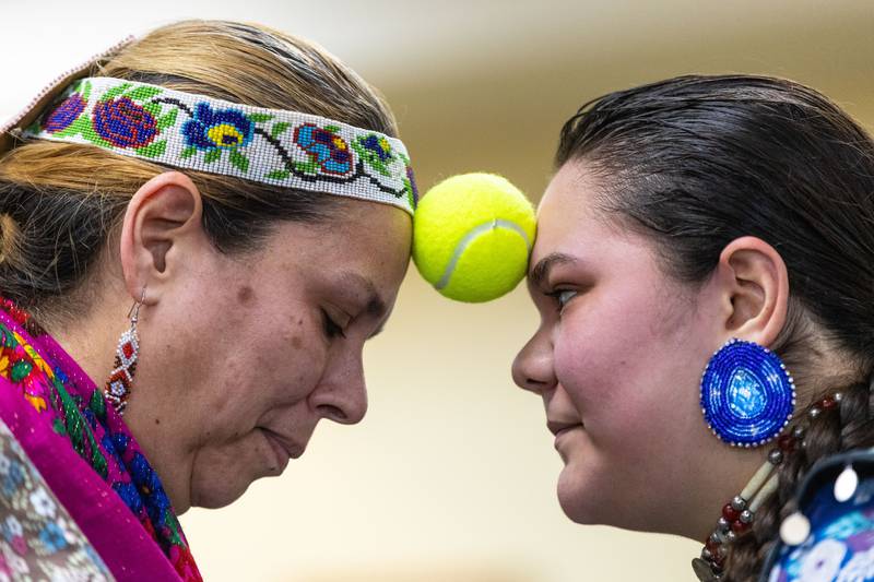 Pretty Rock Big Bear, right, and her mom Madalene Big Bear perform a traditional potato dance with a tennis ball during the Welcome Winter Celebration at the Lost Valley Visitor Center in Ringwood on Saturday, Dec. 28, 2024. The celebration included traditional indigenous music, dance and traditional activities for attendees.