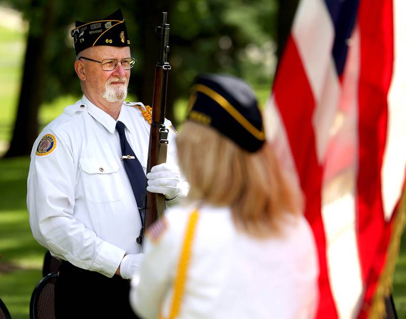 Members of the DeKalb American Legion Post 66 Honor Guard remove the flags Monday, May 26, 2025, following the Memorial Day ceremony at Ellwood House in DeKalb.