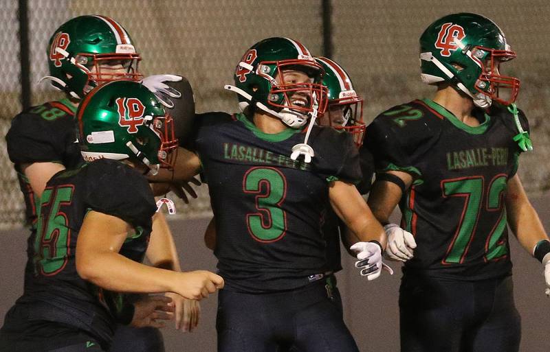 L-P's Rylynd celebrates with teammates Gus Konieczki and Brady Twardowski celebrate after scoring a touchdown against Ottawa on Friday, Oct. 3, 2025 at Howard Fellows Stadium.