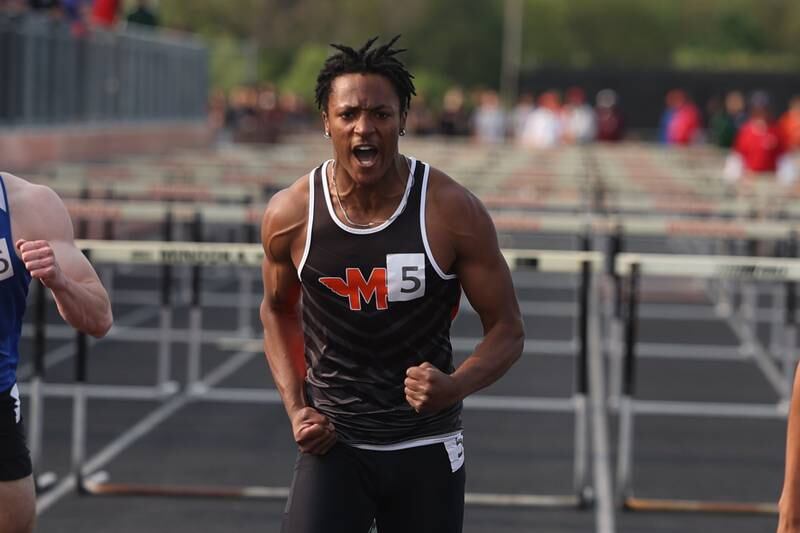 Minooka’s Darvell Smith celebrates finishing in the 110m Hurdles and moving on to the State Finals at the Class 3A Minooka Boys Track and Field Sectional on Wednesday, May 17, 2023 in Minooka.