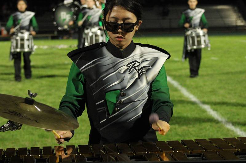 Members of the Rock Falls marching band performs a "Secret Agent" competition routine featuring music from famous spy films.