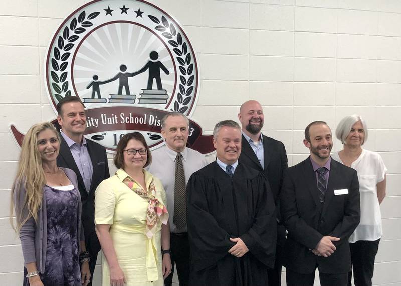 Newly seated St. Charles District 303 School Board members pose for a photo during a special meeting Thursday May 11, 2023.