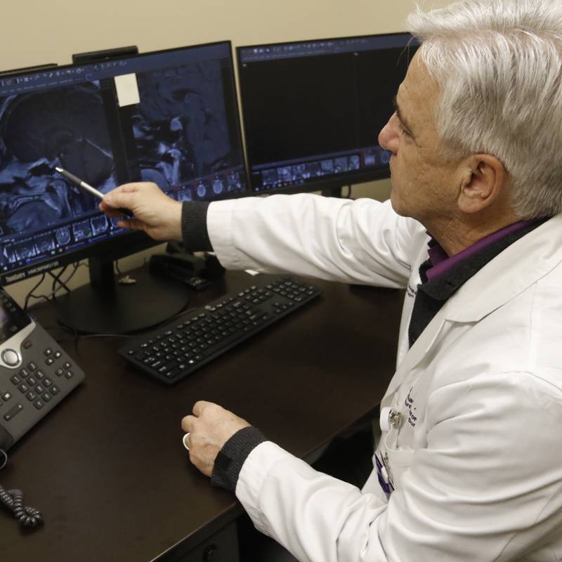 Dr. Michael Caron of Northwestern Medicine McHenry Hospital looks at an image of a brain tumor on Thursday, Jan. 18, 2024, in the Northwestern Medicine Huntley Hospital medical office building.
