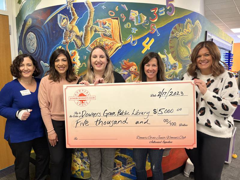 Downers Grove Junior Woman's Club (DGJWC) Members Kristen Avery and Lindsay Garrity present their donation to DGPL Board President Swapna Gigani, Director Julie Milavec, and Children’s Services Manager Allyson Renell.