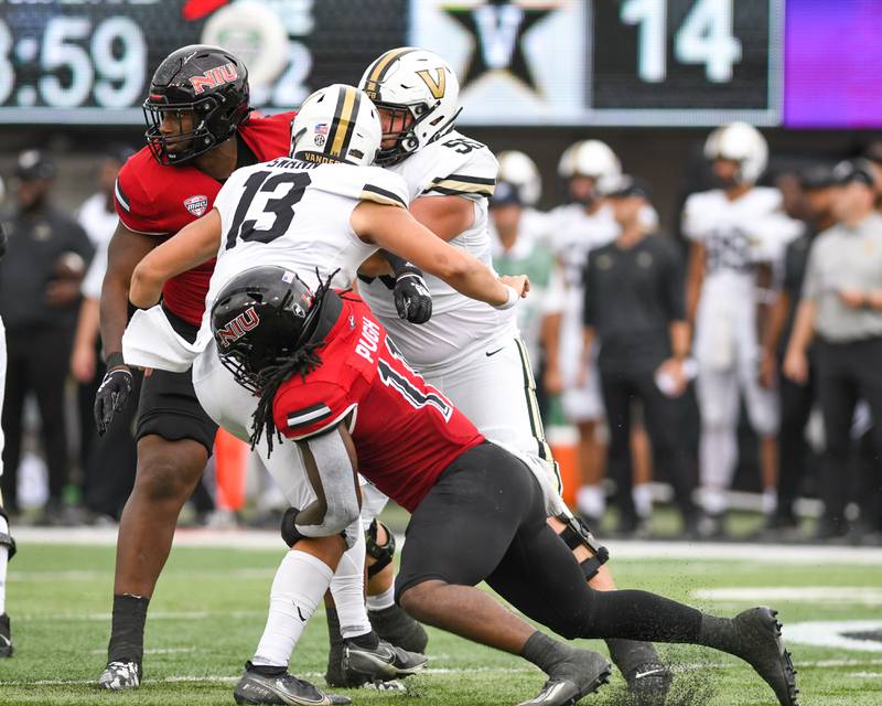 Northern Illinois Huskie Kyle Pugh (11) tries to tackle a Vanderbilt QB before getting the throw off during the second quarter on Saturday Sep. 17 at Huskie Stadium in DeKalb.