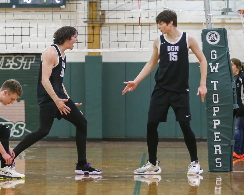 Downers Grove North's Zak Baker (19) and Aaron Grey (15) celebrate a point during volleyball match between Downers Grove North at Glenbard West.  April 2, 2024.