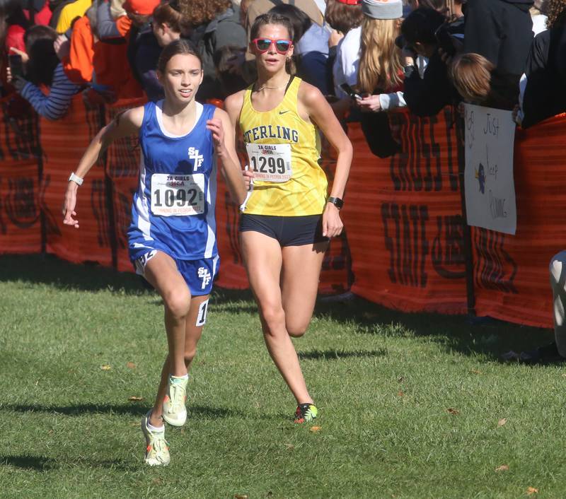 Wheaton St. Francis's Margaret Andrzejwski and Sterling's Ryhlee Wade compete in the Class 2A State Cross Country race on Saturday, Nov. 4, 2023 at Detweiller Park in Peoria.
