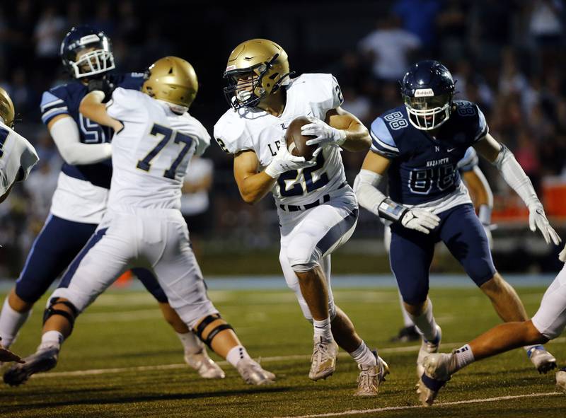 Lemont's Noah Taylor (22) runs the ball during the boys varsity football game between Lemont High School and Nazareth Academy on Friday, Sept. 2, 2022 in LaGrange, IL.