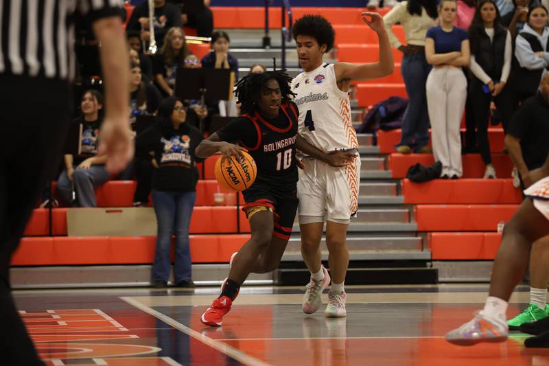 Bolingbrook's Marlon Williams drives along the baseline against Romeoville on Tuesday, Dec. 2, 2025 in Romeoville.