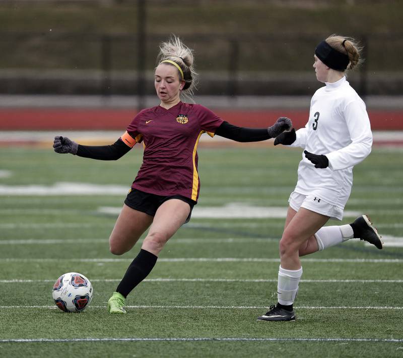Schaumburg's Emma Salatino, left, attacks the goal as Crystal Lake South's Brynn LeFevre puts on some pressure during girls soccer action Saturday, March 26, 2022 in Schaumburg.