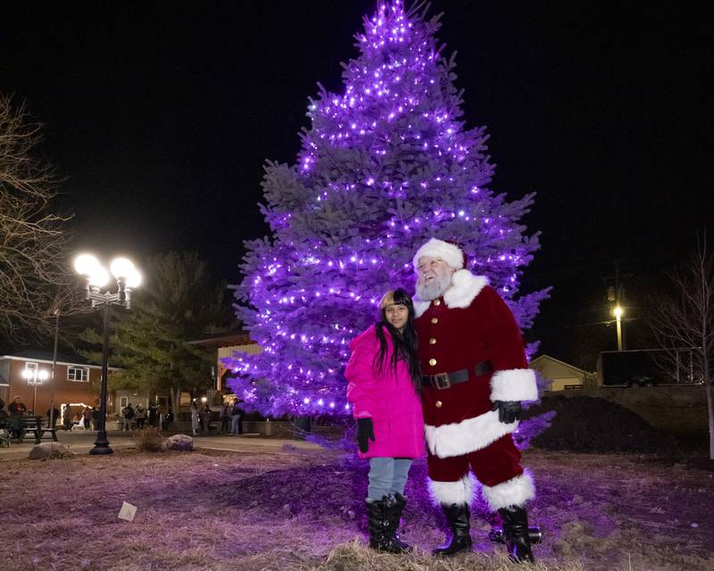Maria Rodriquez poses with Santa downtown after the tree lighting ceremony on November 25, 2023 in Spring Valley.