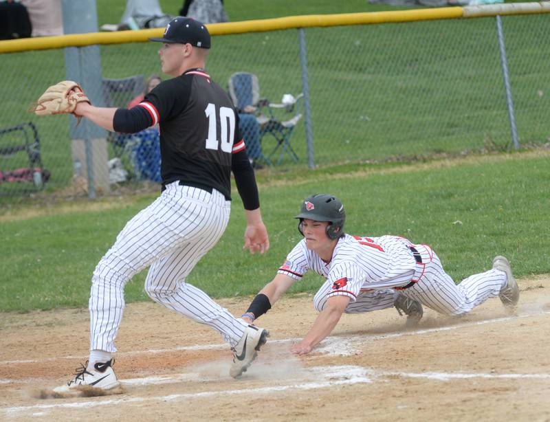 Forreston's Daniel Koehl slides home for a run as Fulton's Dom Kramer covers at the 1A Amboy Regional on Saturday, May 24, 2025.