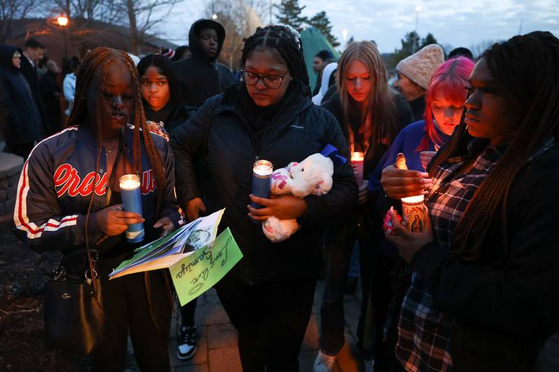 A group of young women stand together a candlelight vigil for the victims of the March 5th shooting on Wednesday, March 8th, 2023 in Bolingbrook.