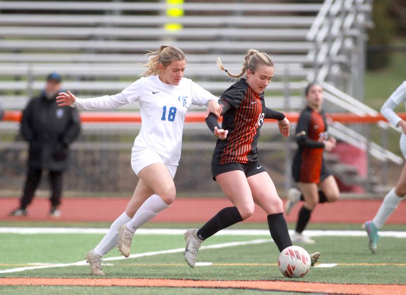 Burlington Central’s Ripley Hamell (left) and St. Charles East’s Payton Rivard (right) go after the ball during a game on Tuesday, April 1, 2025 in St. Charles.