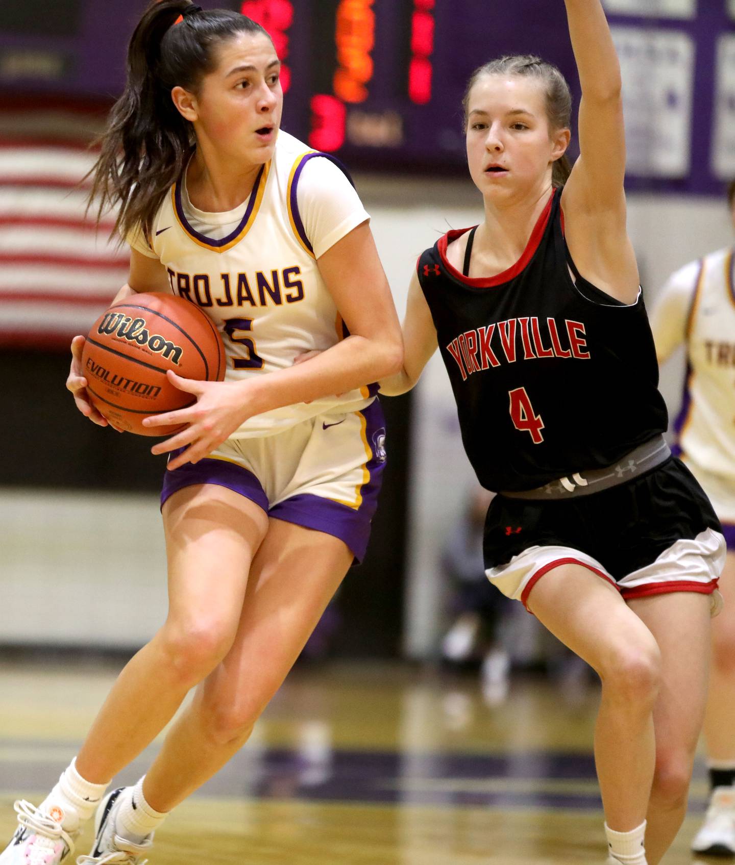 Downers Grove North’s Campbell Thulin dribbles around Yorkville’s Macie Jones during the Class 4A Downers Grove North Regional final on Thursday, Feb. 15, 2024.