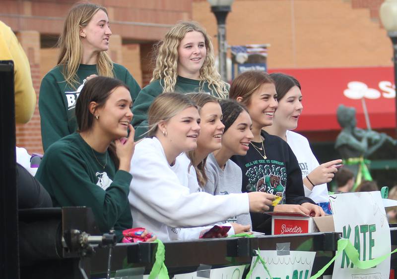 St. Bede volleyball players ride on a a float during the St. Bede Homecoming parade on Friday, Sept. 27, 2024 downtown Peru.