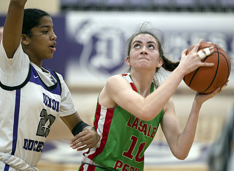 LaSalle-Peru’s Bailey Pode looks to put up a shot against Dixon’s Ahmyrie McGowan Thursday, Nov. 30, 2023 in Dixon.