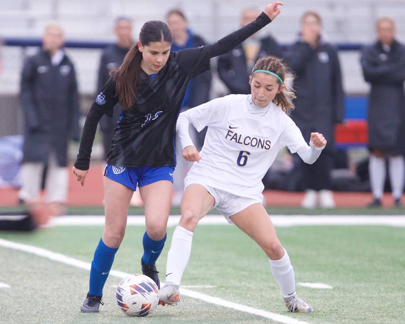 St. Charles North's Keira Connolly battles for the ball with Wheaton North's Grace Kuczai  on Thursday, April 10,2025 in St. Charles.