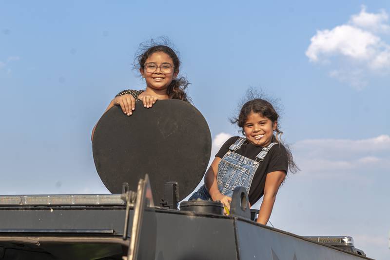 Renesmay (L) and Zendaya explore a police rescue vehicle at the Joliet Police Department's National Night Out event Tuesday, Aug 5, 2025  in Joliet.