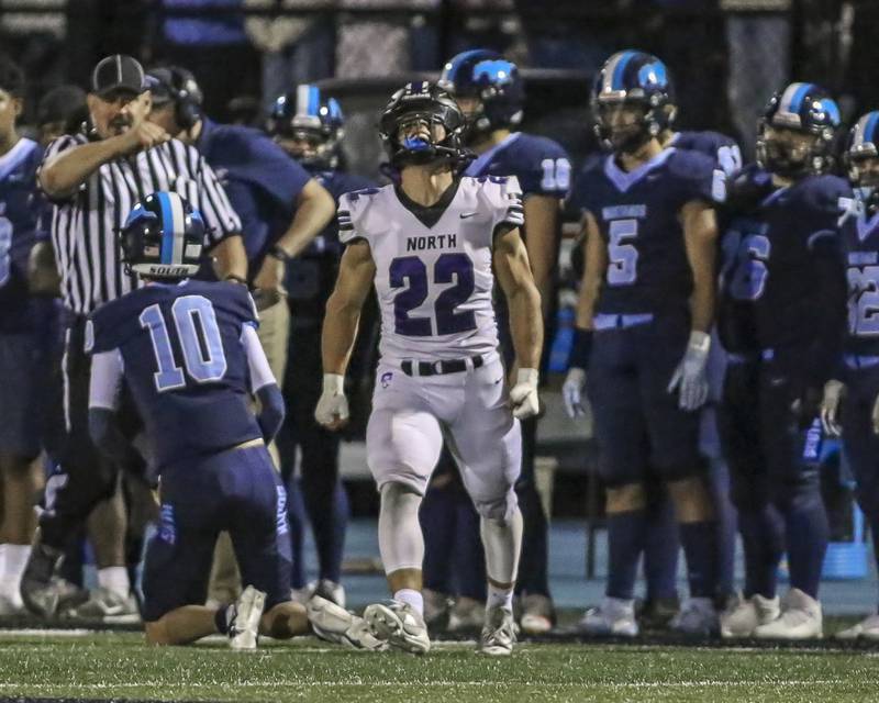 Downers Grove North's Joe Lasota (22) celebrates his sack of Downers Grove South's James Sobkowiak (10) during football game between Downers Grove North at Downers Grove South Friday, Sept 5, 2025  in Downers Grove.