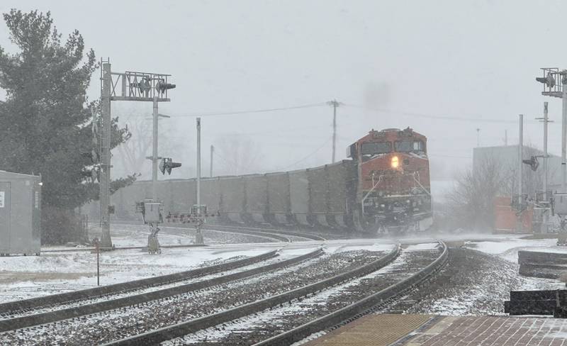 A BNSF freight train passes through a crossing in the light snow on Wednesday, Feb. 12, 2025 in Princeton.