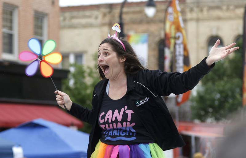 Emily Kunash of Next Level Counseling and Wellness, has fun as she takes part in the Woodstock PrideFest Parade Sunday, June 11, 2023, around the historic Woodstock Square.