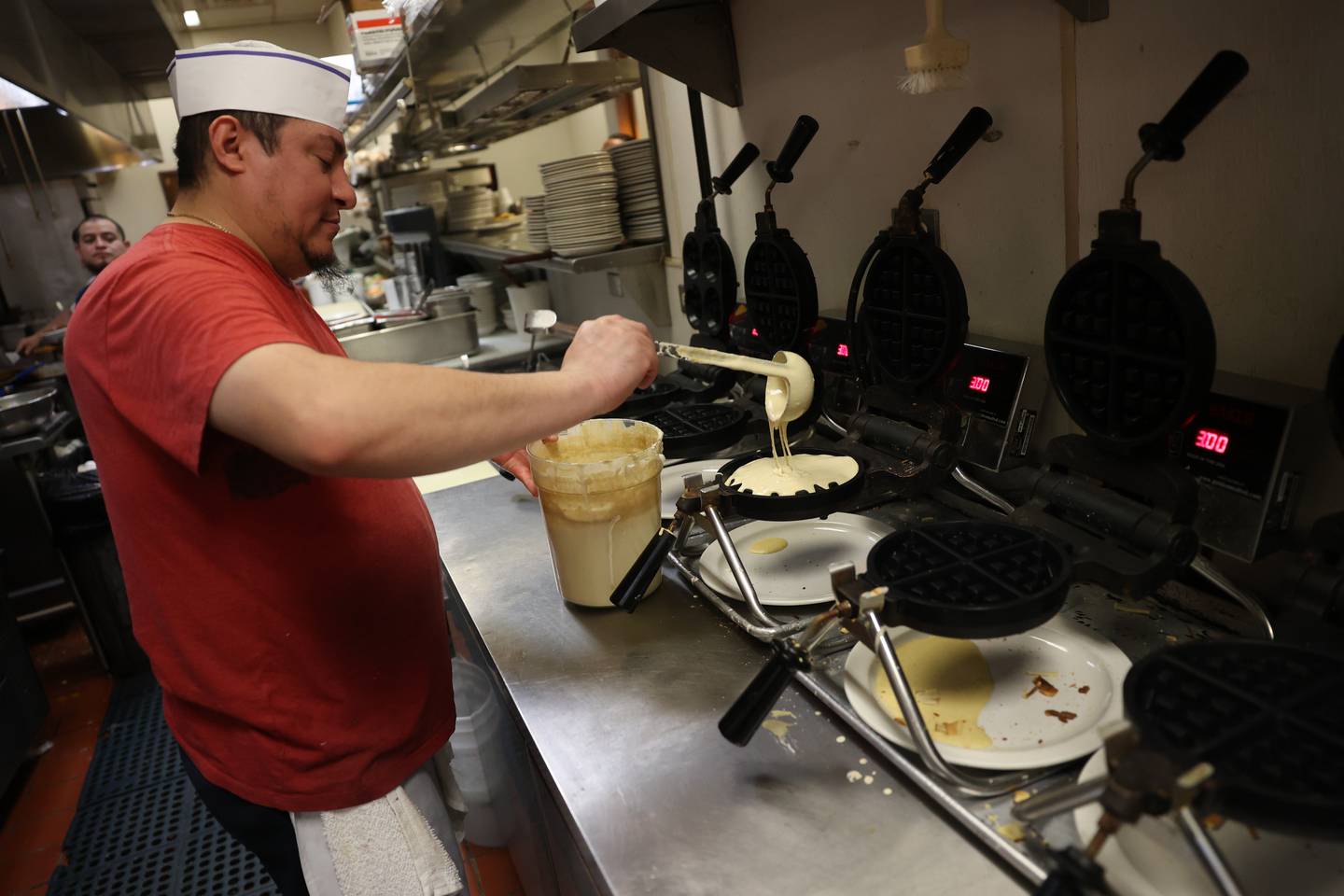 Pedro Hernandez prepares a waffle order at Tasty Waffle in Romeoville.