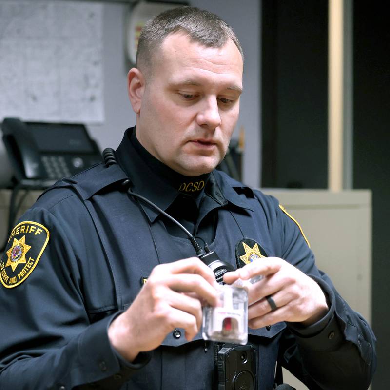 DeKalb County sheriff's deputy Doug Brouwer shows one of the Narcan sprays he carries at all times and describes how he administers the opioid overdose treatment on Friday, March 22, 2024, at the Sheriff’s Office in Sycamore.